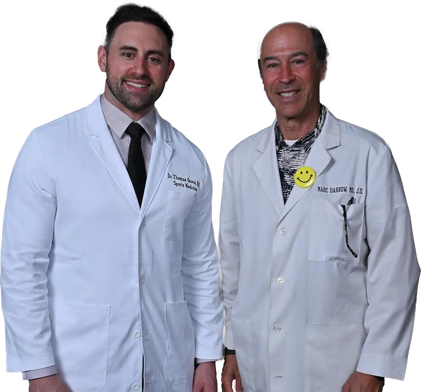 Two certified, licensed sports therapists consulting with a patient in a clinic treatment room