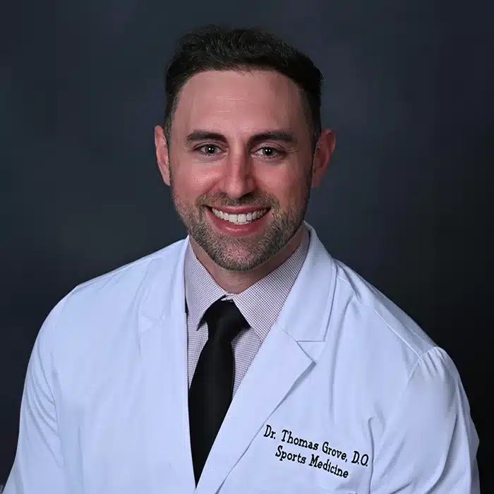 Dr. Thomas Grove consulting with a patient in a clinic setting